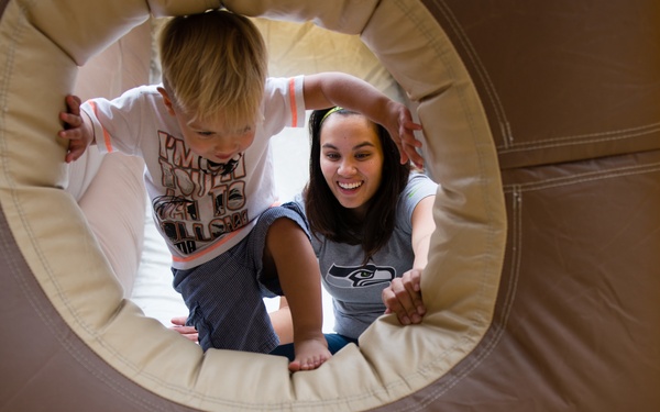 Child playing in a tunnel at EFMP picnic