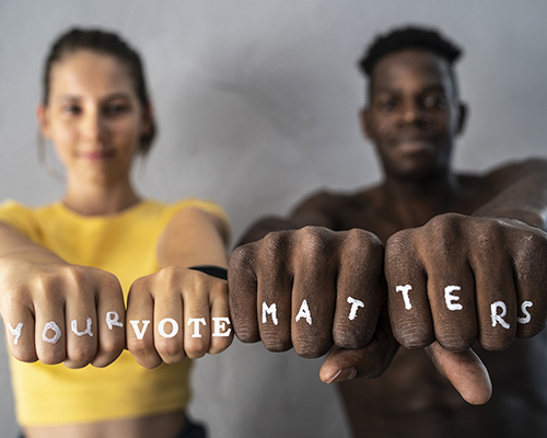 Friends showing their fists with the slogan "Your vote matters"