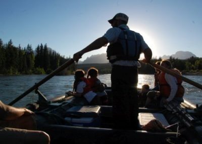 Families observe the beautiful sunset from a boat