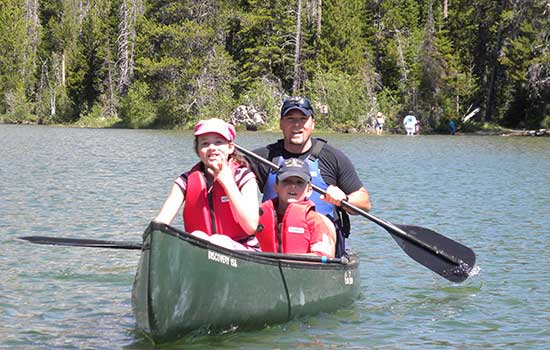 Family paddling a canoe